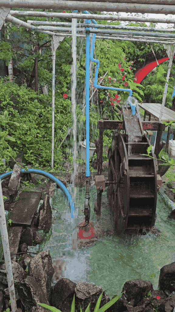 Moving waterwheel and falling water in the garden at Janggun Sikdang.