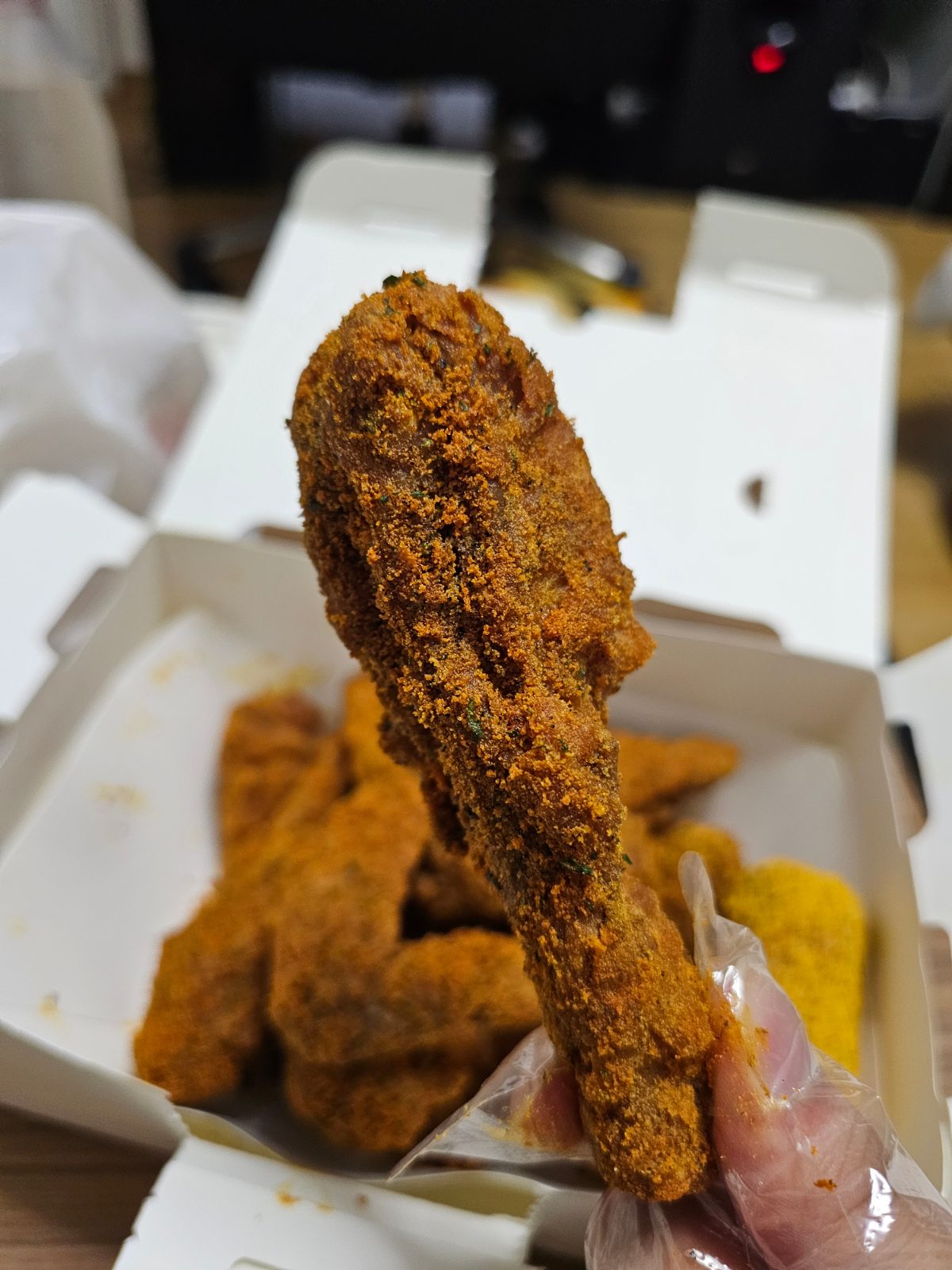 Currinkle chicken drumstick held up close