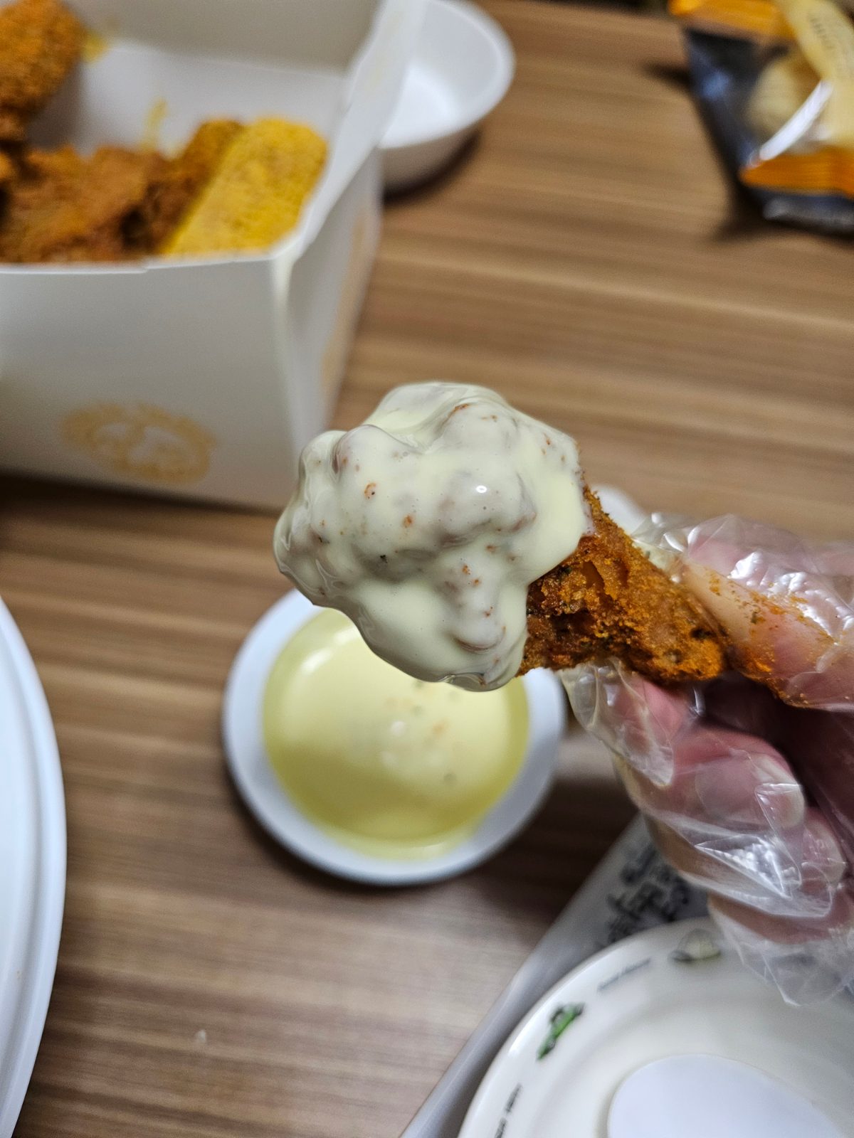 Currinkle chicken dipped into the included sauce