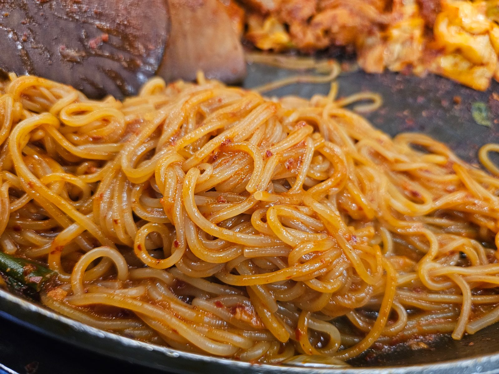 Close-up of jjolmyeon noodles mixed with spicy dakgalbi sauce