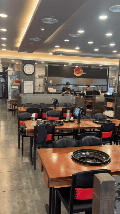 Interior dining area at Yugane Dakgalbi Daegu Dongseongro with grill tables