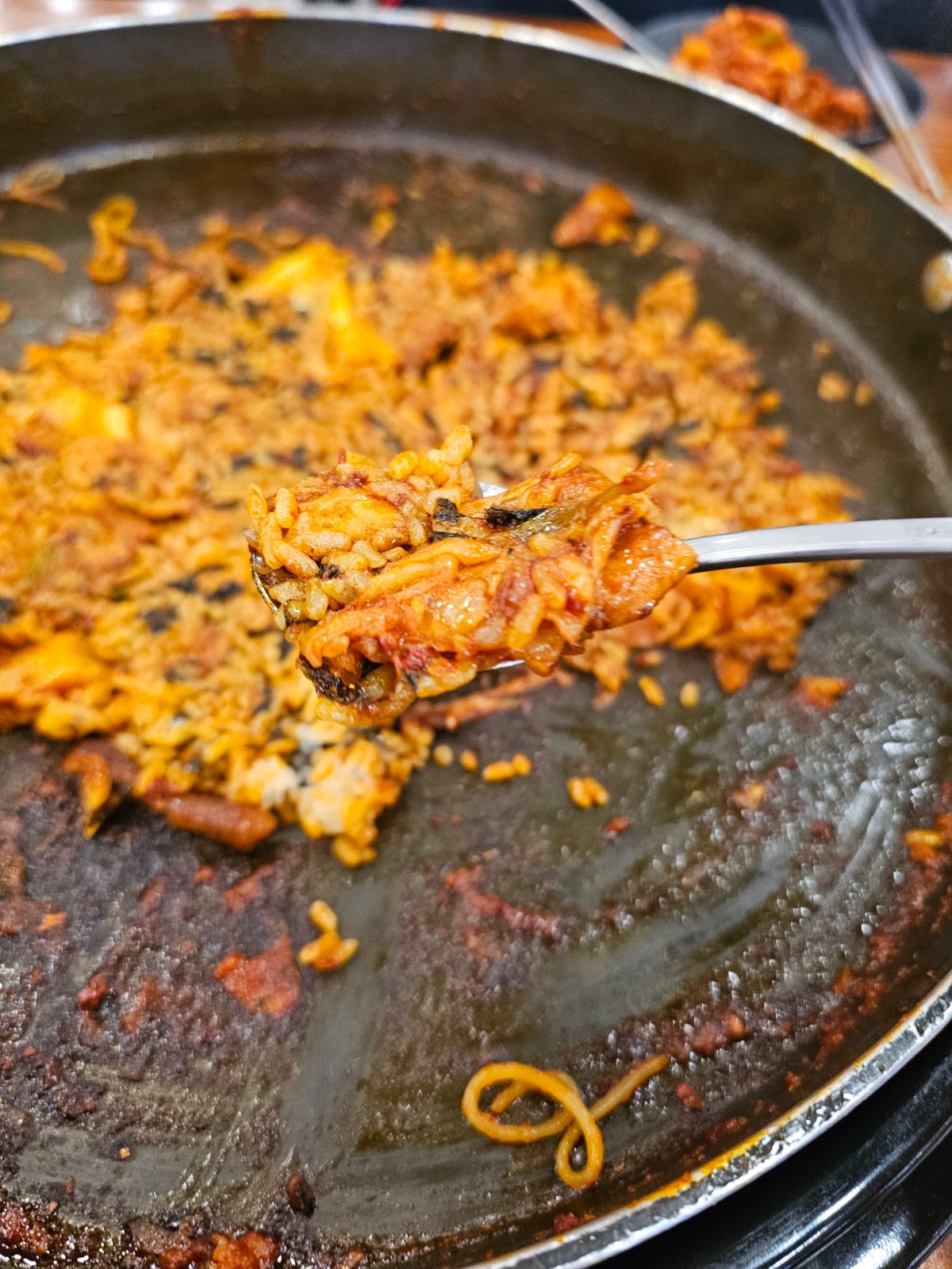 Spoonful of bokkeumbap lifted from the dakgalbi pan