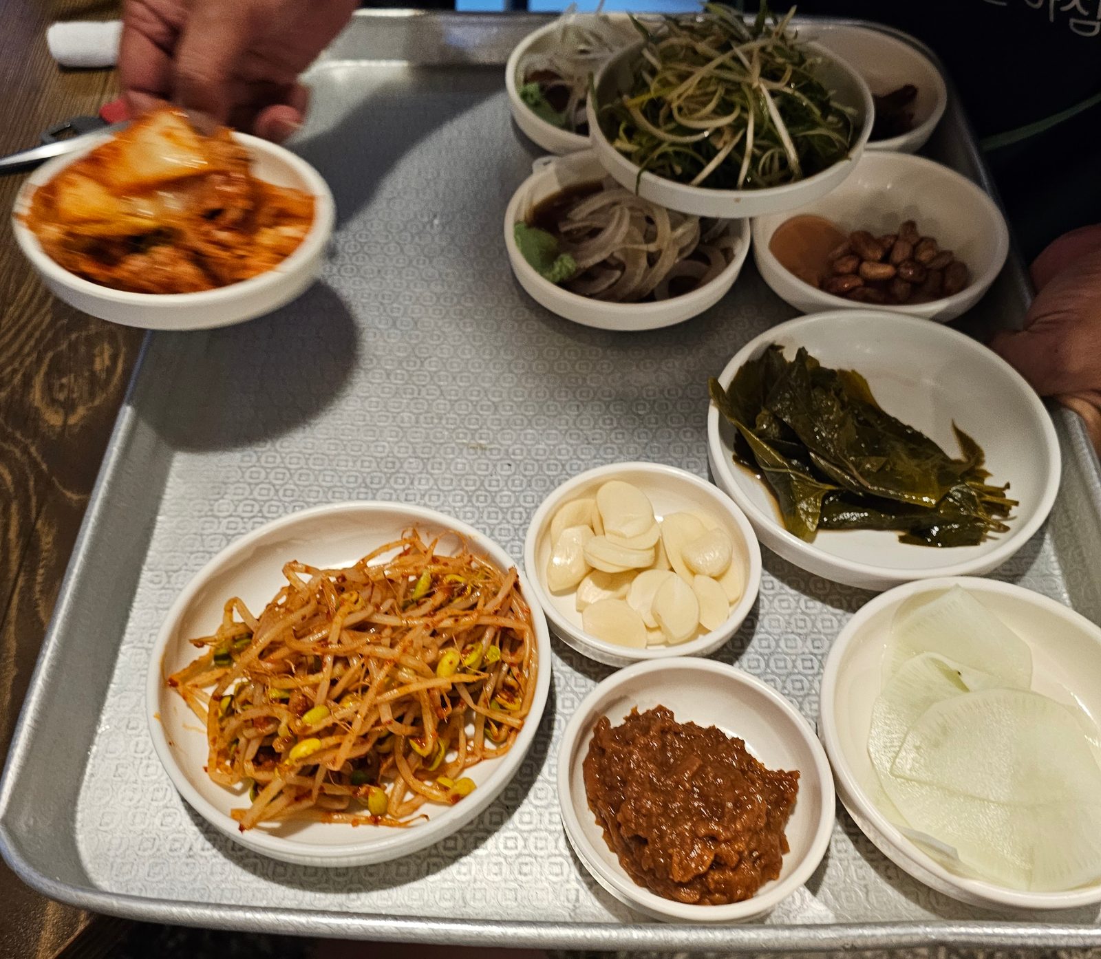Table setting with house-made kimchi and pickled mulberry leaves
