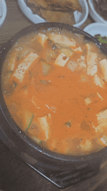 Bubbling doenjang jjigae with tofu served in a hot stone bowl at Eomeoni Sikdang in Daejeon