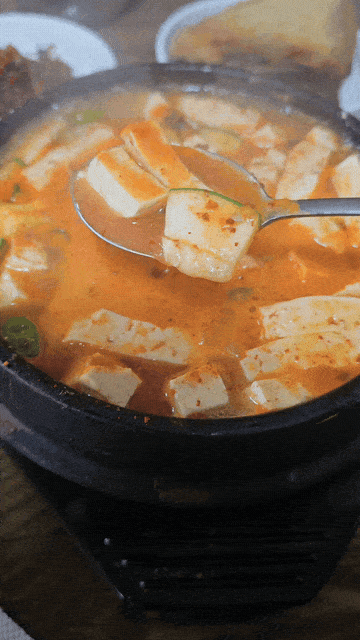 Spoonful of hot doenjang jjigae with tofu at Eomeoni Sikdang in Daejeon