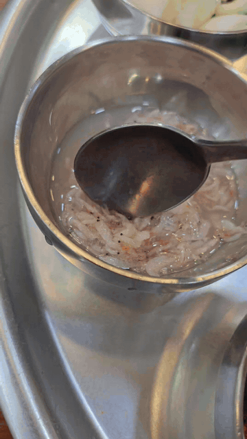 Salted shrimp being added to a small condiment bowl