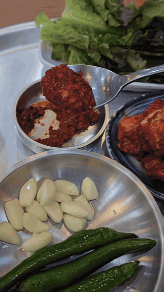 Spicy seasoning added beside garlic, chili, and leafy vegetables
