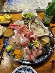 Assorted Sashimi platter with tuna, salmon, oysters, and abalone