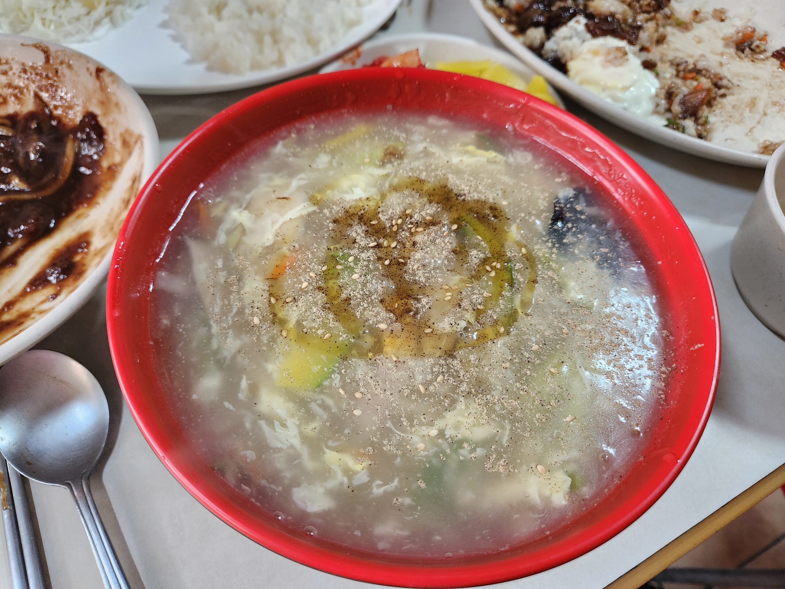 Ulmyeon with egg, zucchini, wood ear mushrooms, sesame seeds, and pepper
