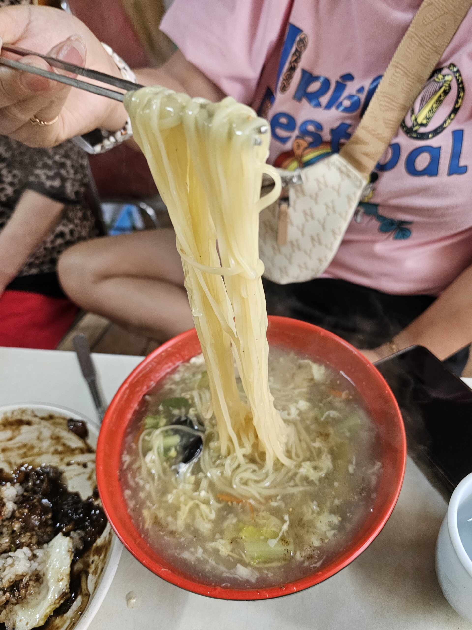 Thin Ulmyeon noodles lifted with chopsticks